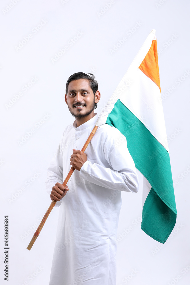 Young indian man holding indian national flag in hand over white background Young indian man holding indian national flag in hand over white background