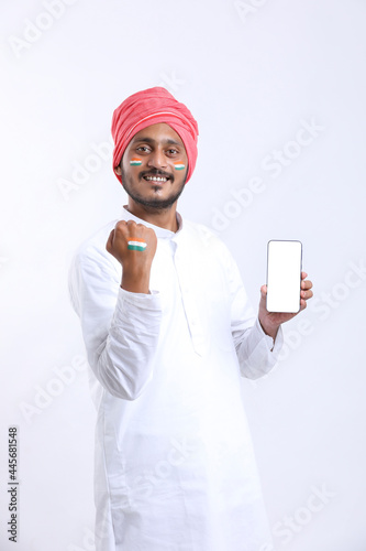Independence day offer concept : Young indian showing smartphone.