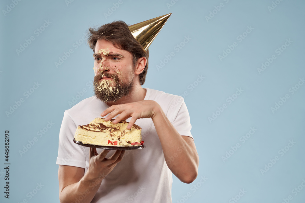 man with a dirty face house with a cake in his hands holiday blue background man with a dirty face house with a cake in his hands holiday blue background