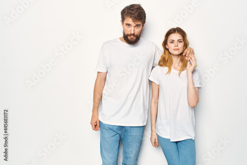 cheerful young couple in white t-shirts embrace friendship lifestyle