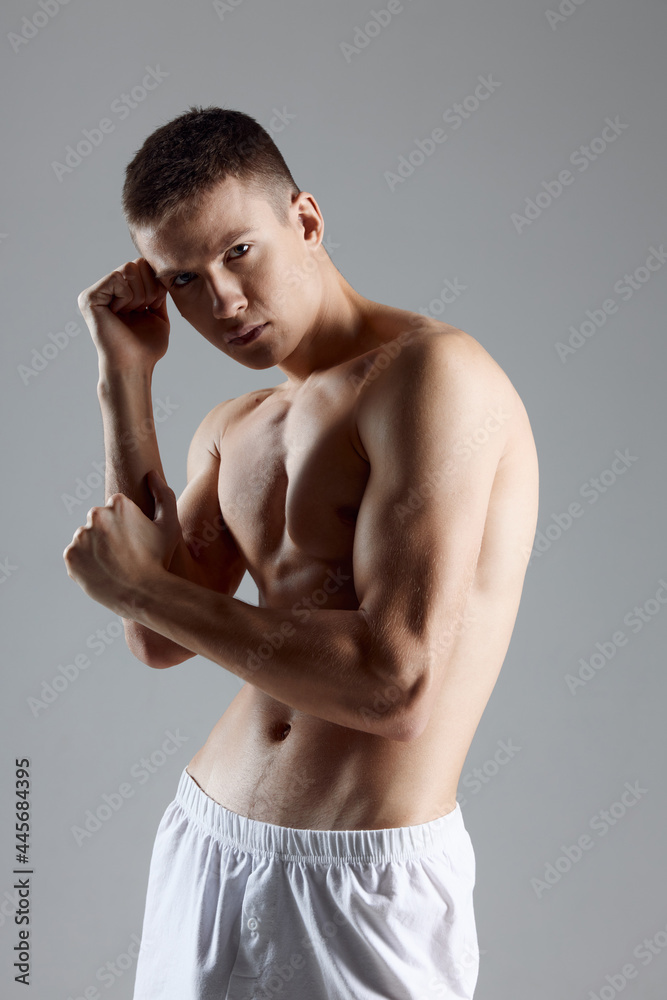 guy with a pumped-up torso and arm muscles bodybuilder fitness portrait 