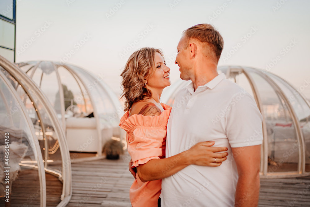 Obraz premium happy, beautiful man and woman in love in original place for dating on rooftop