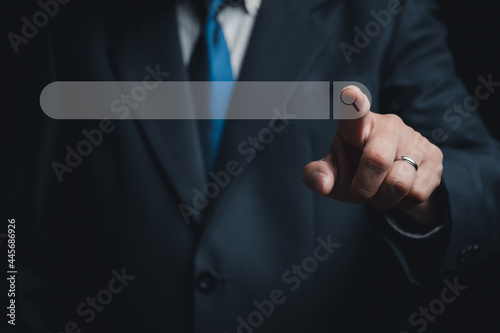 Business man point to magnifying glass icon on search toolbox 