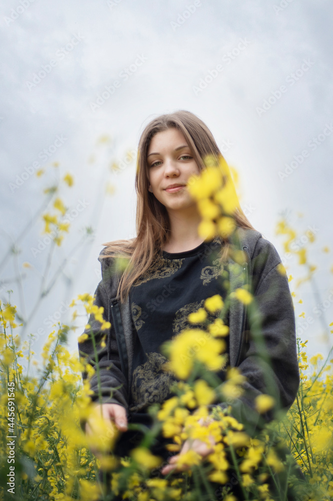 Young girl on yellow rapeseed field Young girl on yellow rapeseed field