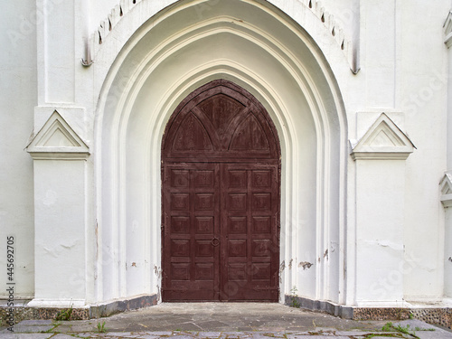 Old arched door to an old church © Sergey