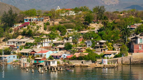 Photography Cuban poor colorful village with church on the hill near city Santiago de Cuba