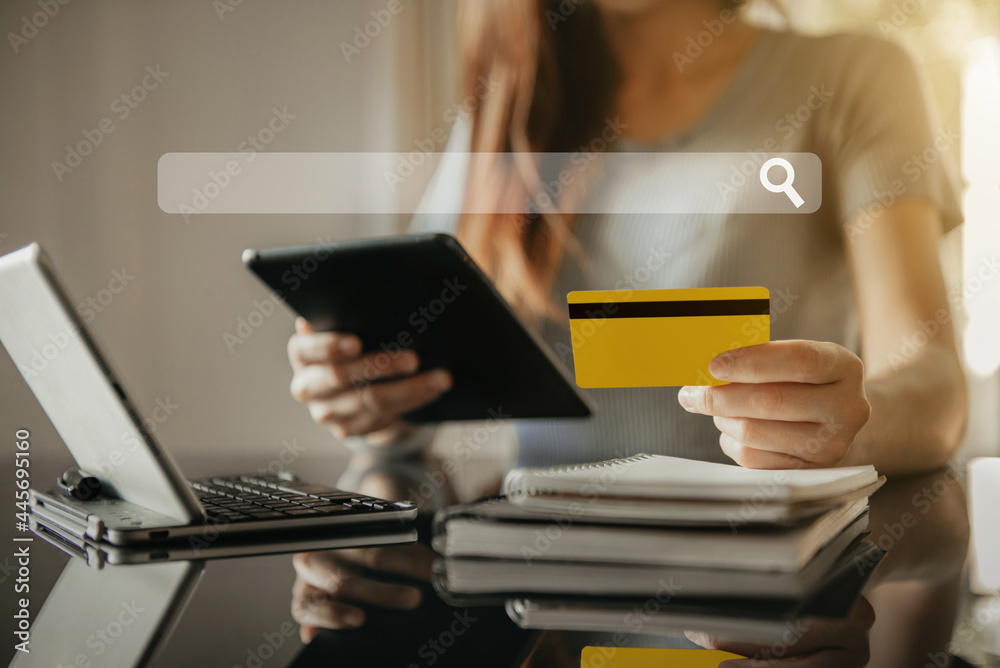 Woman using tablet to search online and pay by credit card on vacation. Woman using tablet to search online and pay by credit card on vacation.