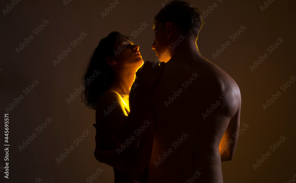 Sexy couple. Sexy photo. Erotica. People. Light. Dark. Background. Dark. Bedroom. Kissing.