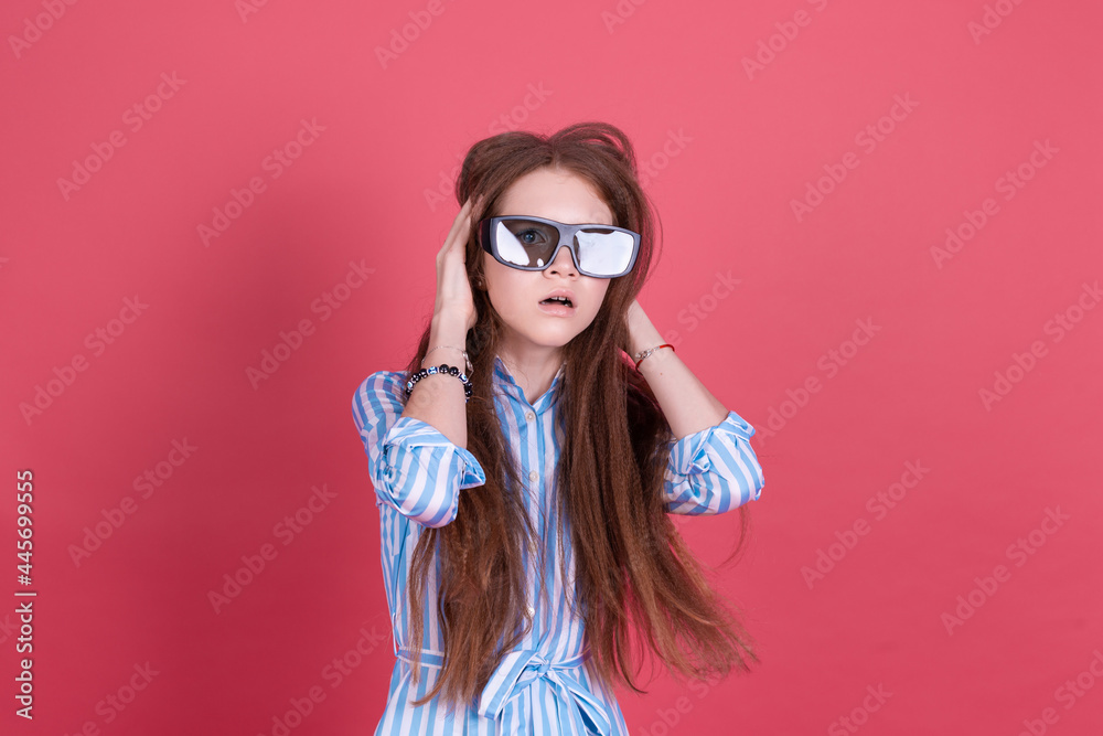 Little kid girl 13 years old in blue dress with brackets isolated on pink background wearing 3d cinema glasses shocked Little kid girl 13 years old in blue dress with brackets isolated on pink background wearing 3d cinema glasses shocked