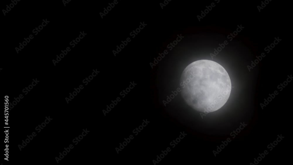 Full glowing mooon in cloudy night with slowly moving light clouds. Full glowing mooon in cloudy night with slowly moving light clouds.