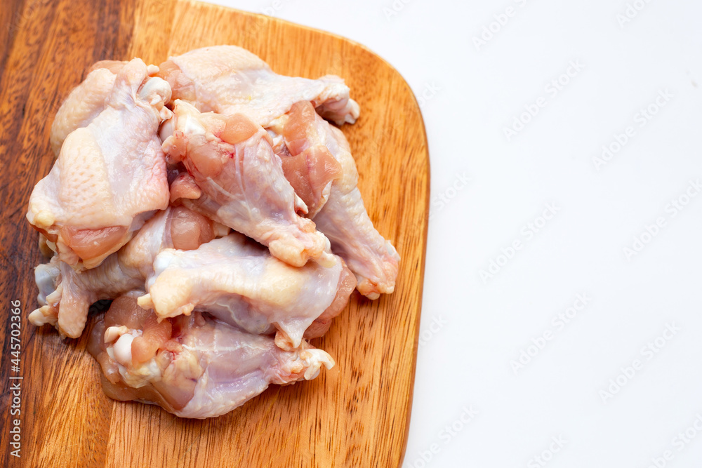 Fresh raw chicken wings (wingstick) on cutting board on white background. Fresh raw chicken wings (wingstick) on cutting board on white background.