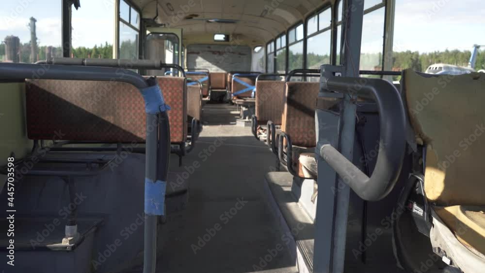 An old rusty broken cabin of an abandoned bus with damaged leather seats. CemeteryRecycling and utilization of public transport. Recyclable materials. The concept of Environmental conservation 4k