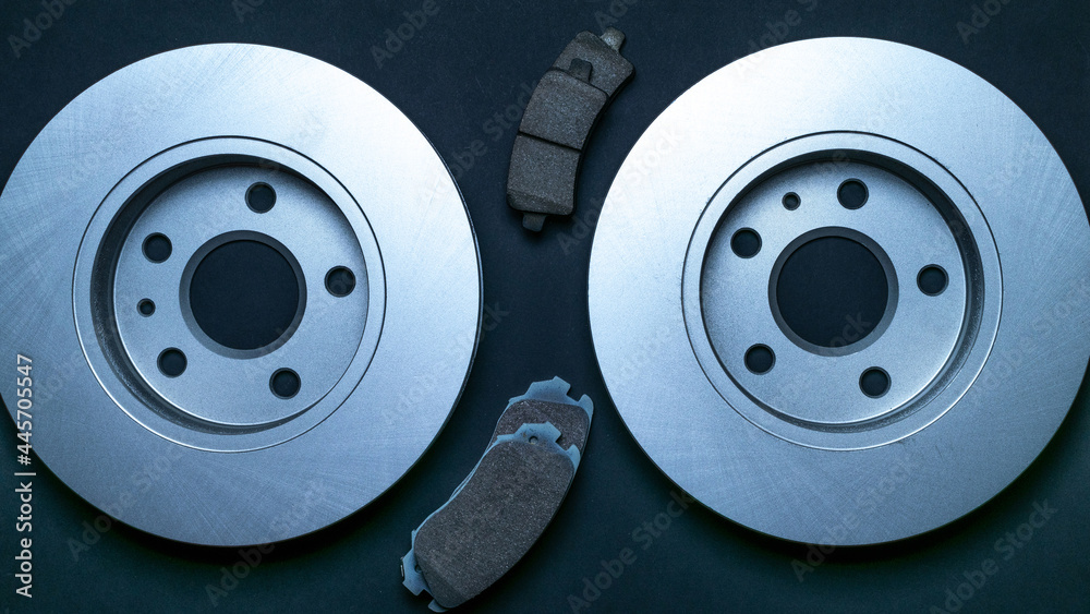 Spare parts. Auto motor mechanic spare or automotive piece on black background. New metal car part. Flat lay, top view, copy space. Spare parts. Auto motor mechanic spare or automotive piece on black background. New metal car part. Flat lay, top view, copy space.