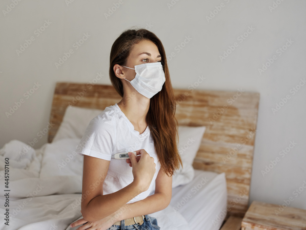 woman in medical mask thermometer armpit temperature check woman in medical mask thermometer armpit temperature check