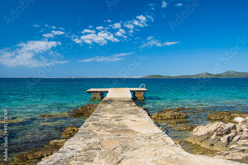 Beach with pier on the Adriatic coast near Pakostane, Croatia photo