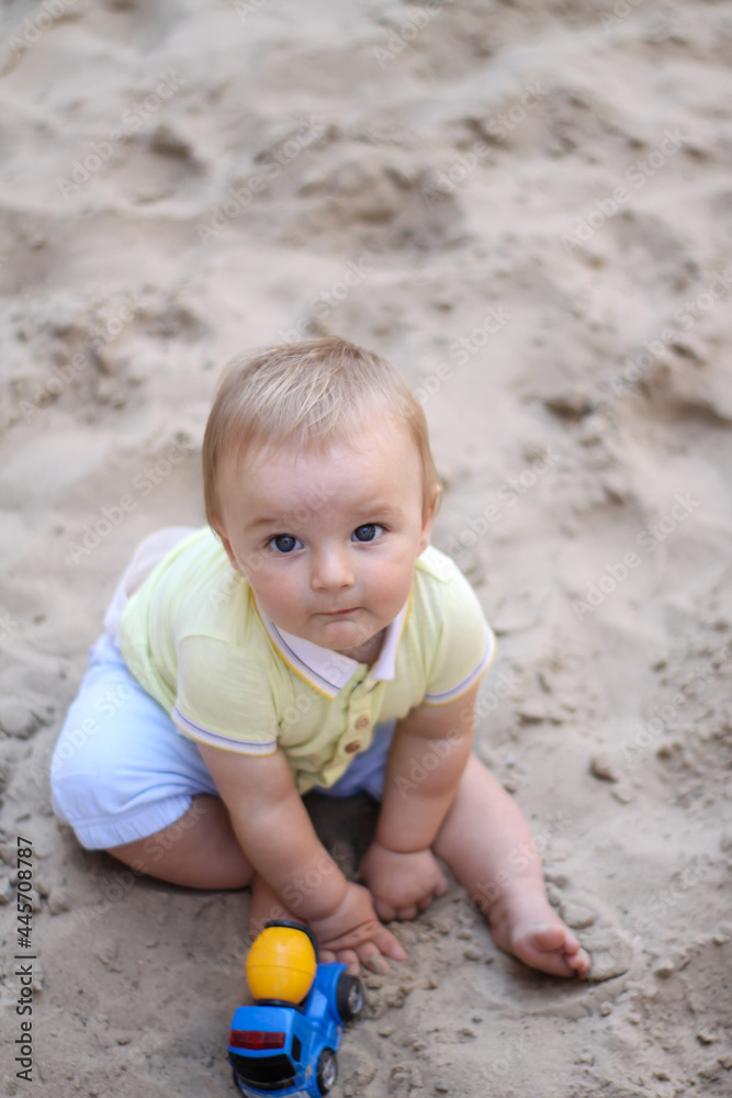 little boy playing in the sand. baby plays with sand. Summer rest. Sun, sea, beach, sand. Rest, childhood. little boy playing in the sand. baby plays with sand. Summer rest. Sun, sea, beach, sand. Rest, childhood.