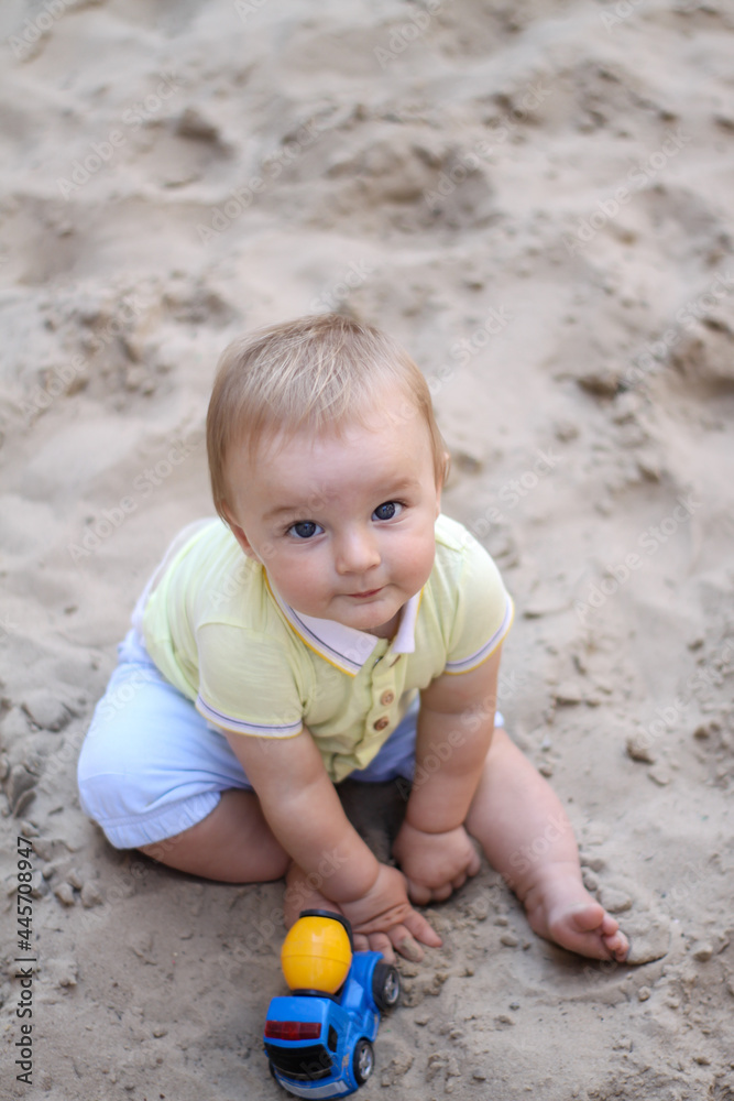 little boy playing in the sand. baby plays with sand. Summer rest. Sun, sea, beach, sand. Rest, childhood. little boy playing in the sand. baby plays with sand. Summer rest. Sun, sea, beach, sand. Rest, childhood.