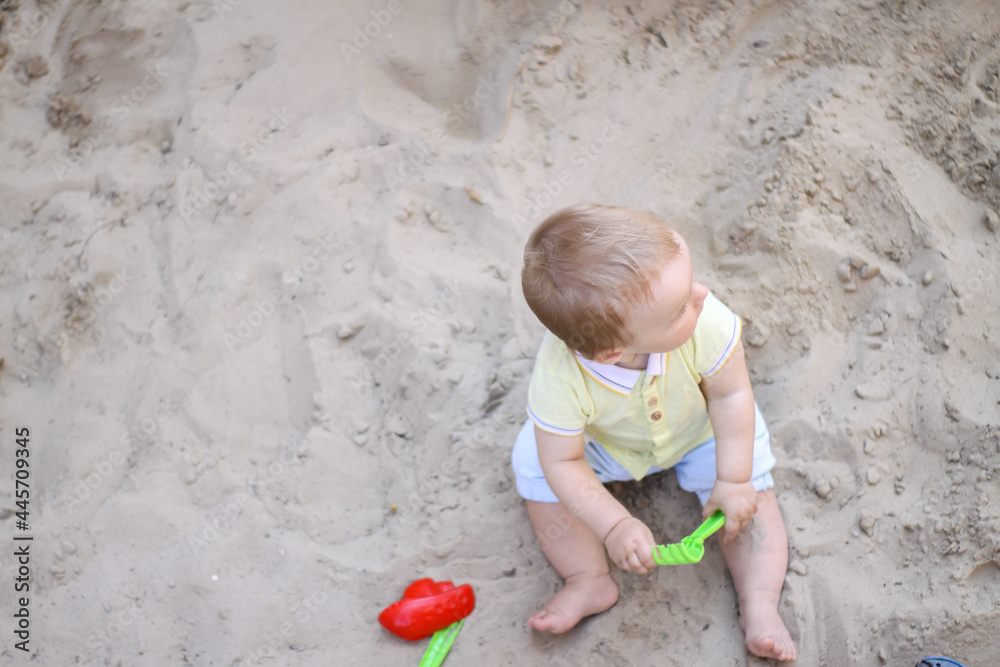 little boy playing in the sand. baby plays with sand. Summer rest. Sun, sea, beach, sand. Rest, childhood. little boy playing in the sand. baby plays with sand. Summer rest. Sun, sea, beach, sand. Rest, childhood.