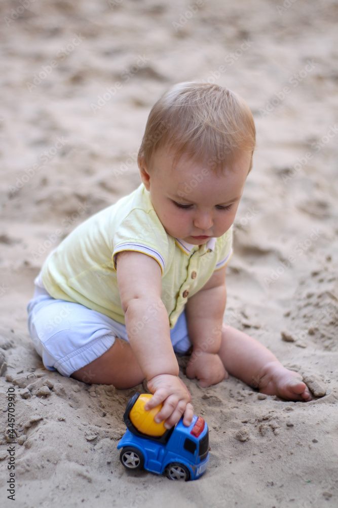 little boy playing in the sand. baby plays with sand. Summer rest. Sun, sea, beach, sand. Rest, childhood. little boy playing in the sand. baby plays with sand. Summer rest. Sun, sea, beach, sand. Rest, childhood.