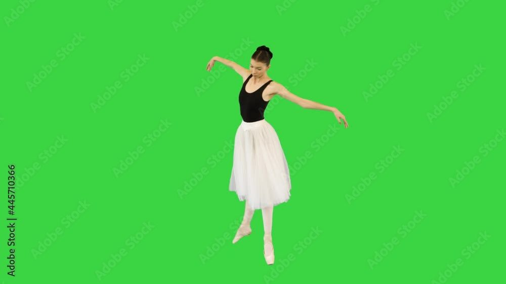 Young ballerina walks demi-pointe performing some ballet movements on a Green Screen, Chroma Key.