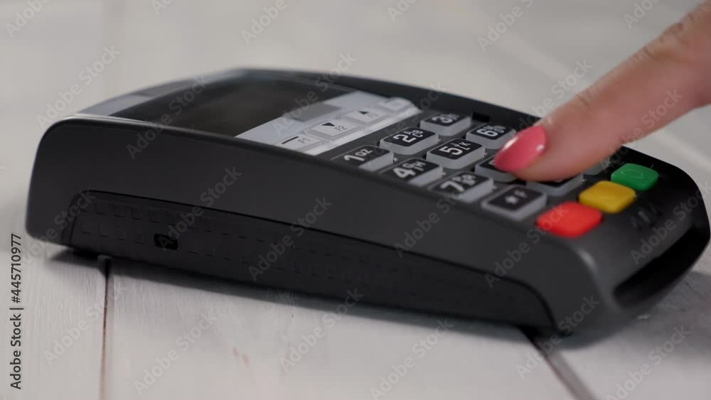Customer hand is entering pin in shop or supermarket on payment terminal. Customer hand is entering pin in shop or supermarket on payment terminal.