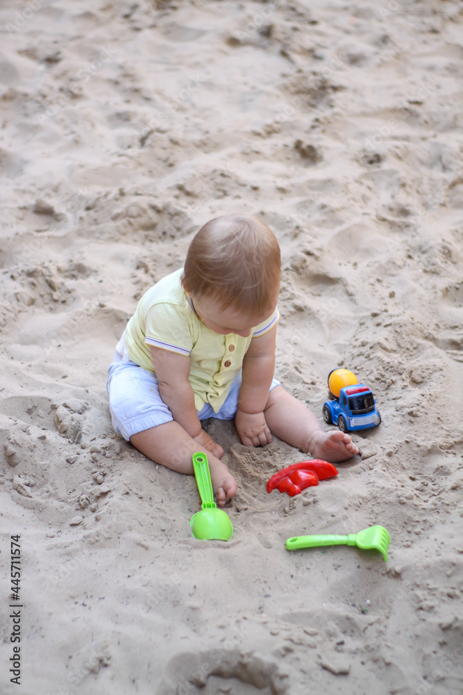 little boy playing in the sand. baby plays with sand. Summer rest. Sun, sea, beach, sand. Rest, childhood. little boy playing in the sand. baby plays with sand. Summer rest. Sun, sea, beach, sand. Rest, childhood.