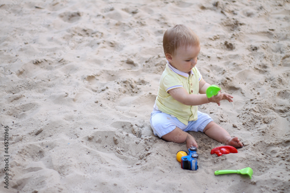 little boy playing in the sand. baby plays with sand. Summer rest. Sun, sea, beach, sand. Rest, childhood. little boy playing in the sand. baby plays with sand. Summer rest. Sun, sea, beach, sand. Rest, childhood.