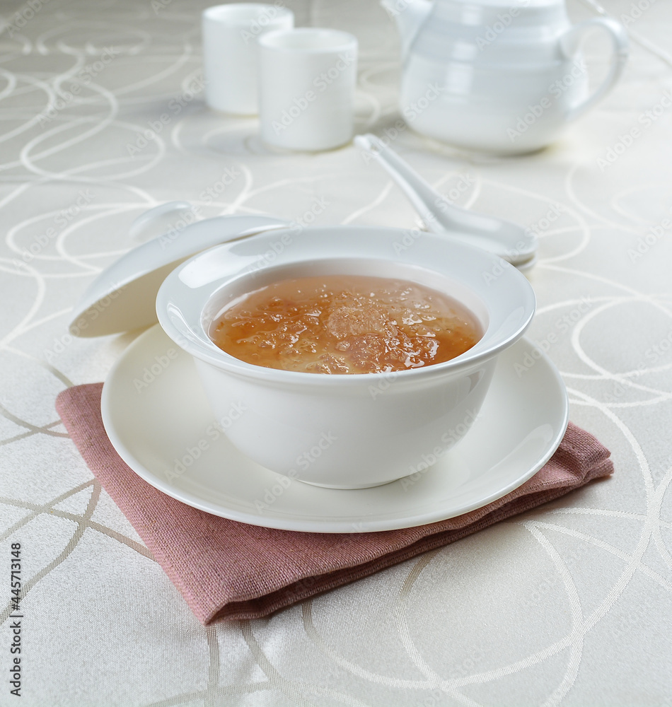 luxury chilled sweet fresh bird nest soup with almond paste and peach resin in bowl and pink table cloth halal healthy dessert menu