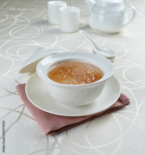 luxury chilled sweet fresh bird nest soup with almond paste and peach resin in bowl and pink table cloth halal healthy dessert menu