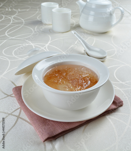 luxury chilled sweet fresh bird nest soup with almond paste and peach resin in bowl and pink table cloth halal healthy dessert menu