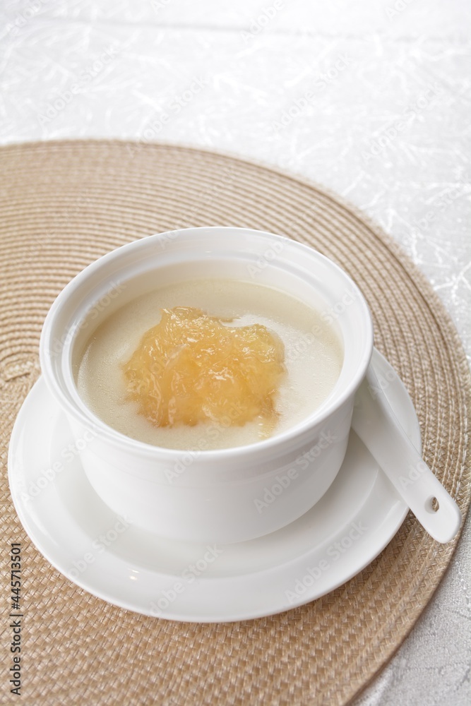 luxury chilled sweet fresh bird nest soup with almond paste and peach resin in bowl and pink table cloth halal healthy dessert menu luxury chilled sweet fresh bird nest soup with almond paste and peach resin in bowl and pink table cloth halal healthy dessert menu