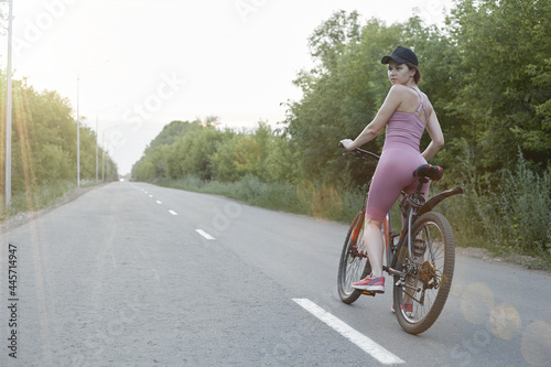 The girl cyclist is engaged in sports, the concept of a healthy lifestyle
