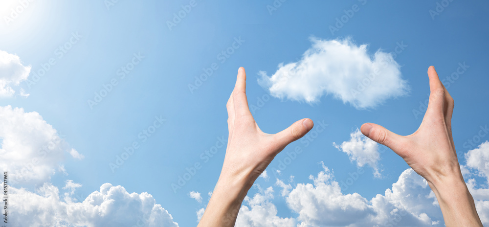 Male hand holding house icon on blue background. Property insurance and security concept.Real estate concept.Weather conditions, cloudiness.Banner with copy space Male hand holding house icon on blue background. Property insurance and security concept.Real estate concept.Weather conditions, cloudiness.Banner with copy space