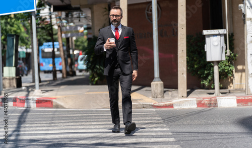 Lifestyle Professional Businessman in suit Walking near Work place. Confident Business man Leadership Concept.