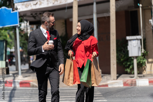 Confident Businessman and Young Muslim Woman Talking on Street. 