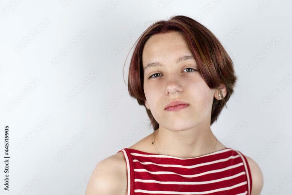 A young teen girl with short painted hair with a heavy character looks as if from above, she does not respect people, thinks that everyone is against her, the problems of adolescence A young teen girl with short painted hair with a heavy character looks as if from above, she does not respect people, thinks that everyone is against her, the problems of adolescence