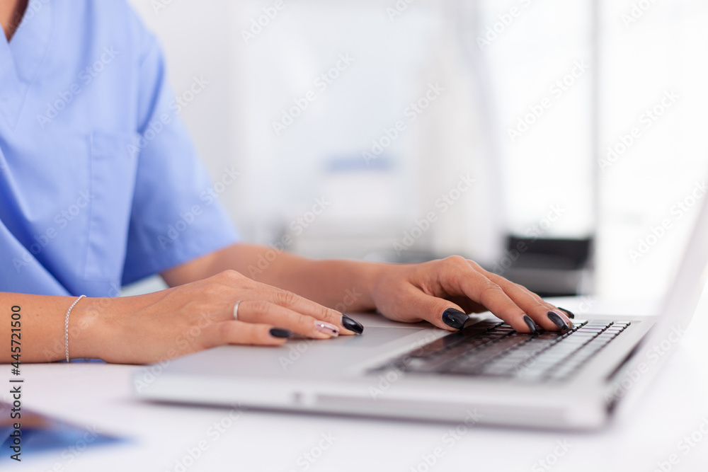 Close up of medical specialist typing on laptop in hospital office. Health practitioner searching in hospital database using laptop in hospital cabinet, keyboard, job. Close up of medical specialist typing on laptop in hospital office. Health practitioner searching in hospital database using laptop in hospital cabinet, keyboard, job.
