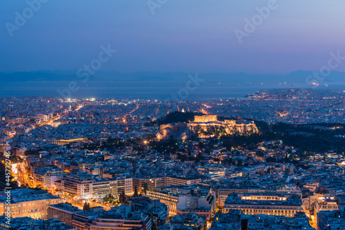 Aerial view of Athens city and Acropolis illuminated after sunset, Greece © PGS