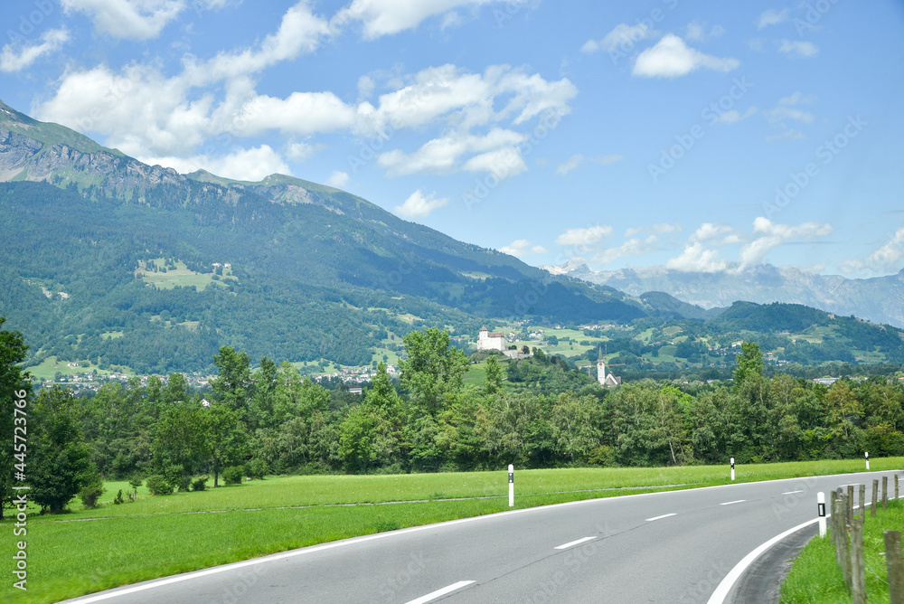 country road through the Principality of Liechtenstein, view to Balzers village and fortress Gutenberg