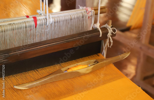 Konstfotografi Closeup of golden cotton cloth weaving with  traditional handloom