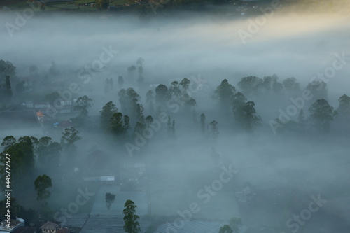 fog covers a village in the valley of Mount Batur, Kintamani Bali
