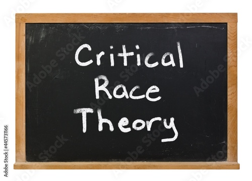 Critical race theory written in white chalk on a black chalkboard isolated on white photo