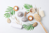 Spa treatment with natural skin care products, herbal bags, towel and wash on white background. Flat lay.