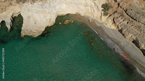 Aerial drone photo of picturesque small fishing harbour of Mandrakia with traditional boat houses called syrmata and anchored fishing boats, Milos island, Cyclades, Greece photo