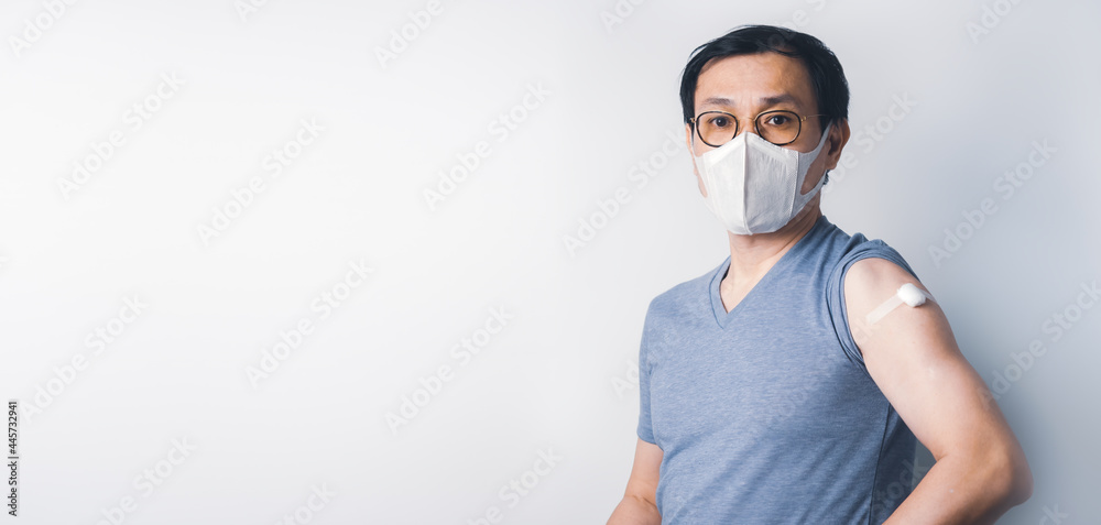 Asian man show cotton after make injection Covid-19 or Coronavirus vaccination immunity on his arm Asian man show cotton after make injection Covid-19 or Coronavirus vaccination immunity on his arm