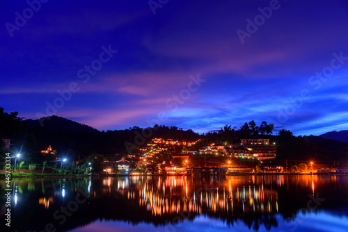 Beautiful colorful twilight sky and reflecting water at Ban Rak Thai the village is surrounded by mountain in Mae Hong Son, Thailand.