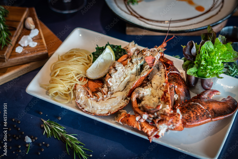 Grilled canadian lobster serve with butter chilli sauce with lemon and salt. Grilled canadian lobster serve with butter chilli sauce with lemon and salt.