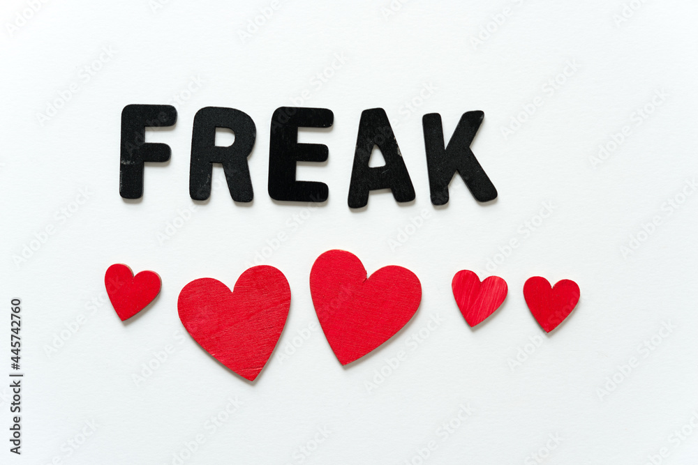 freak spelled out in black chalk letters along with hand painted red heart on white