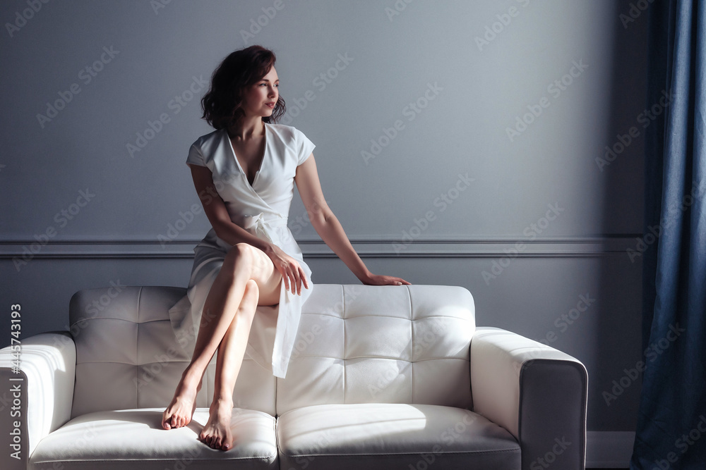 Woman middle aged relaxing on comfortable soft sofa in living room