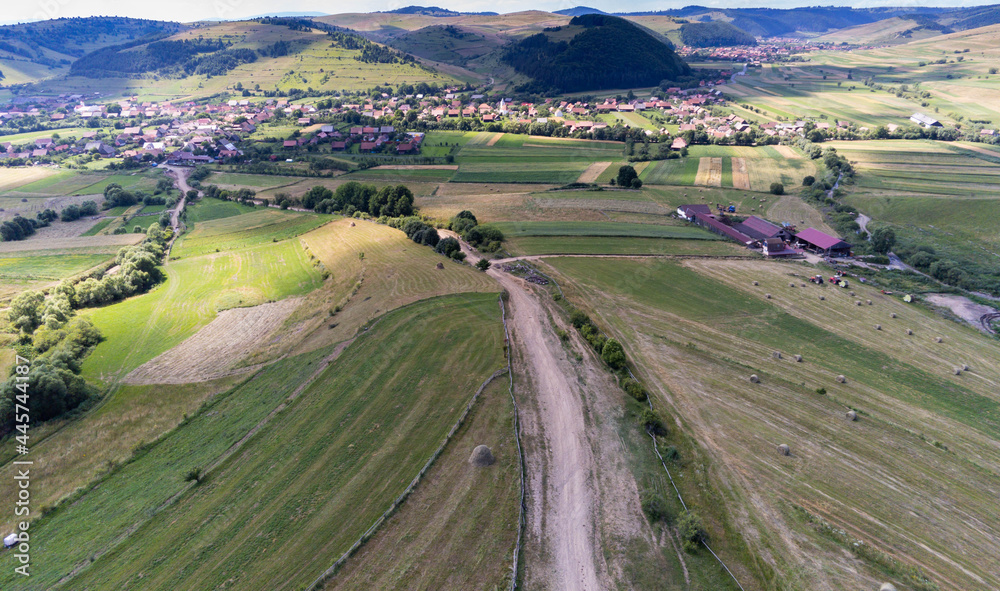 Aerial drone view, small typical hungarian villagesurrounded by beautiful mountains at summer.